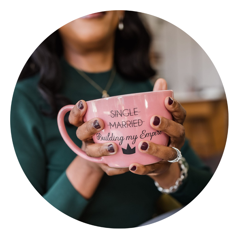 A pink mug with “single” and ”married” crossed out, and with the text “Building my Empire” with a black crown.